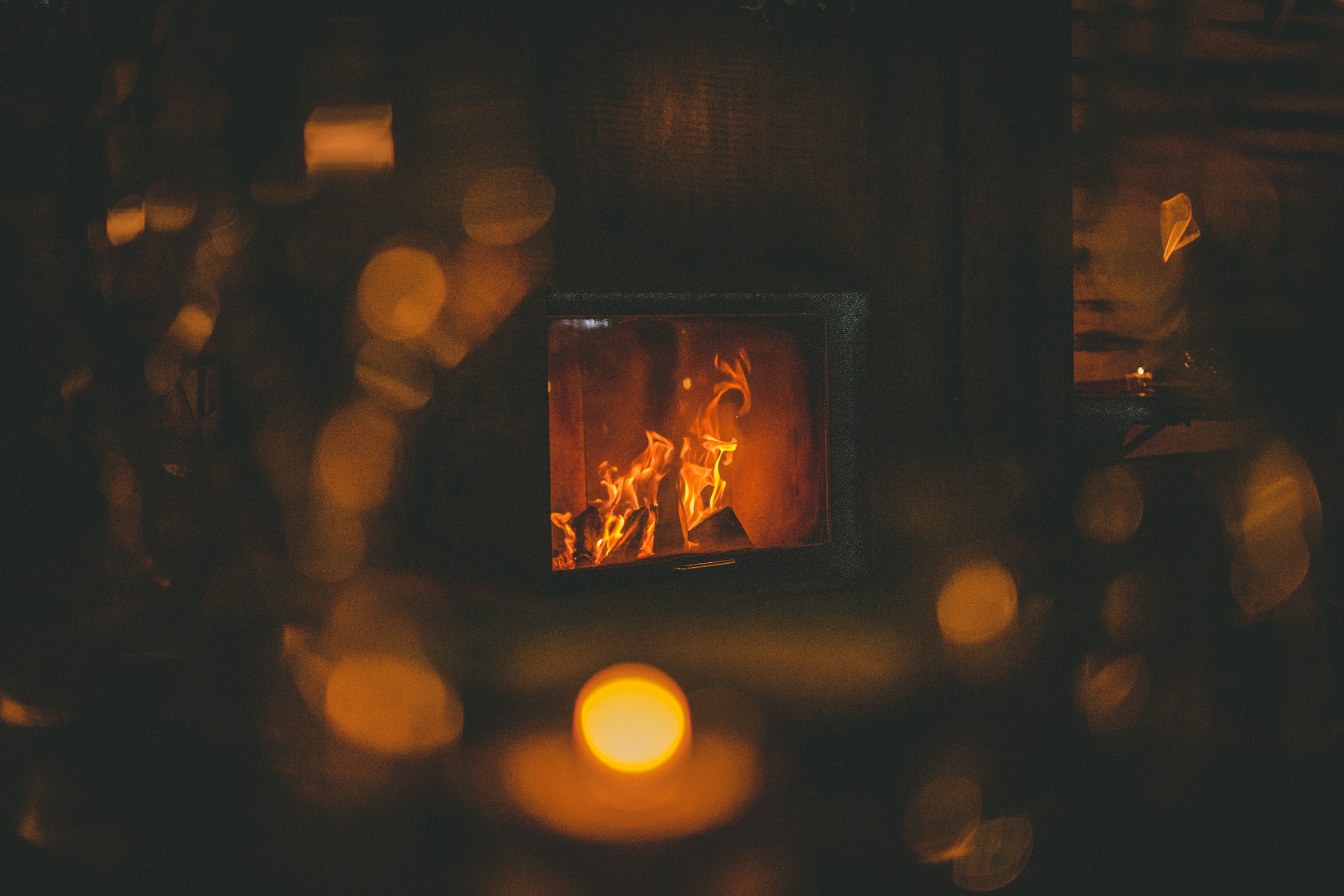 Cozy fireplace in a mountain chalet with warm apres-ski atmosphere