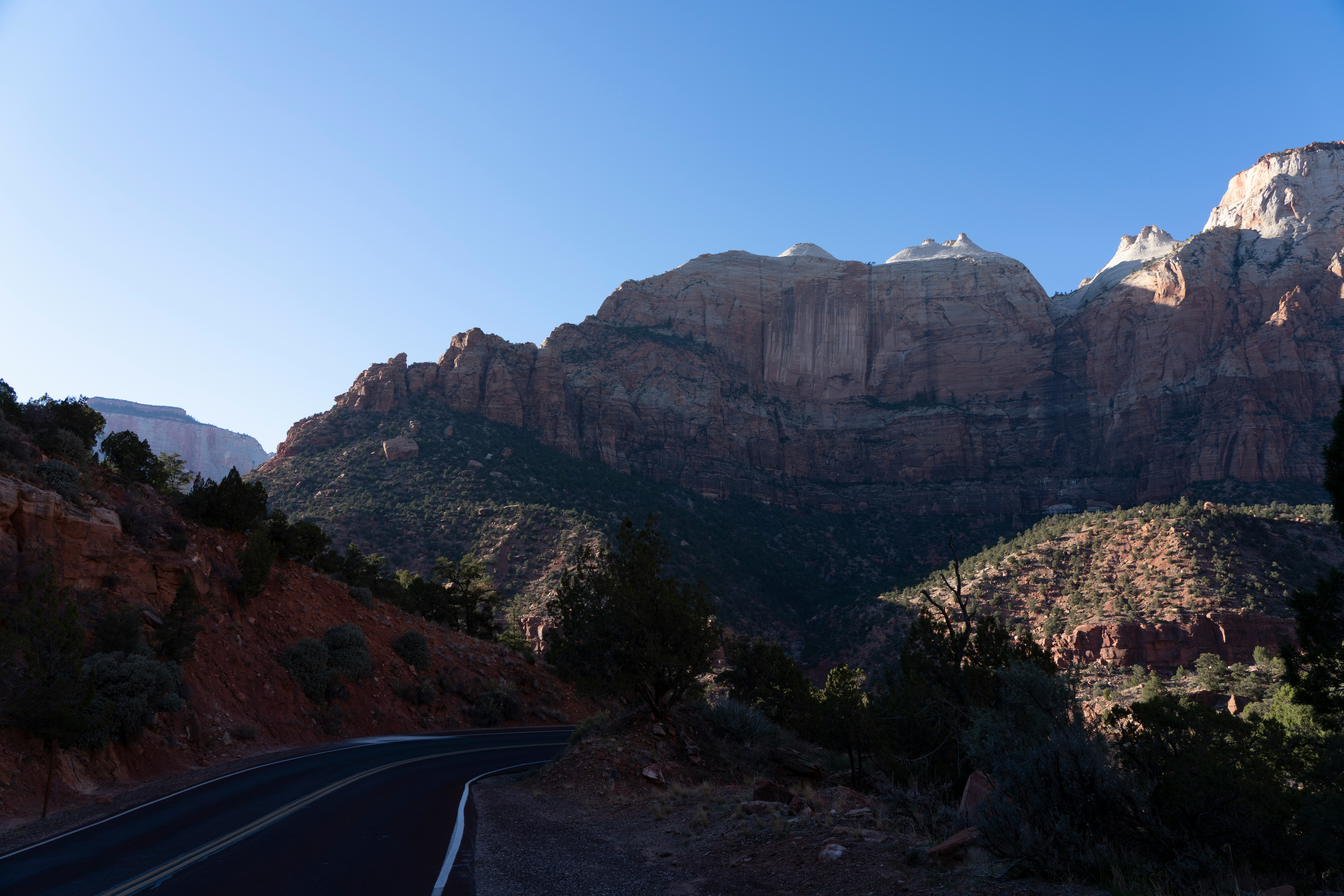 Open Utah highway leading into red rock mountain country, the classic Grand Circle road trip landscape from a Kanab base camp