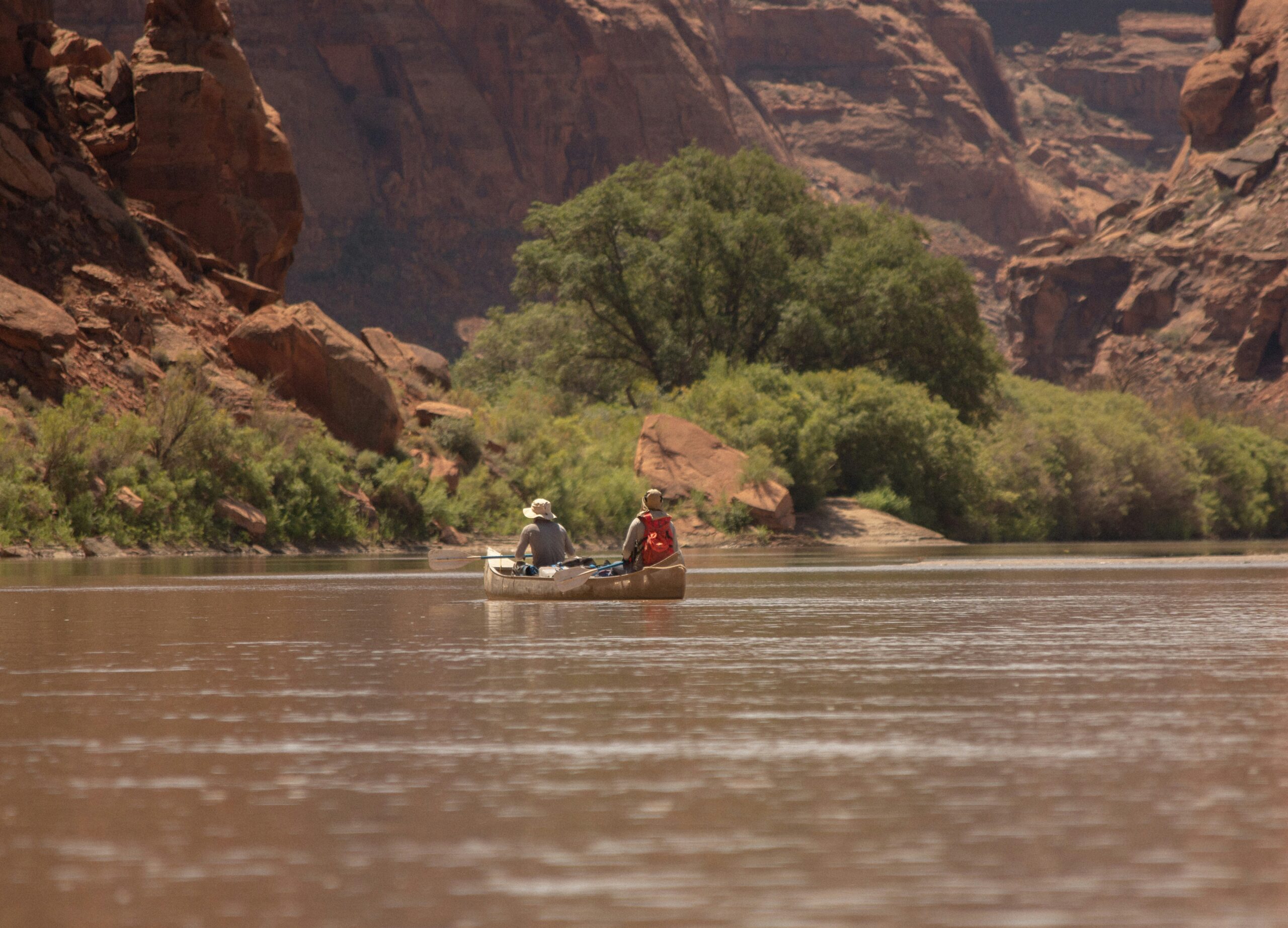 Rafters floating a red rock river canyon near Moab, Utah