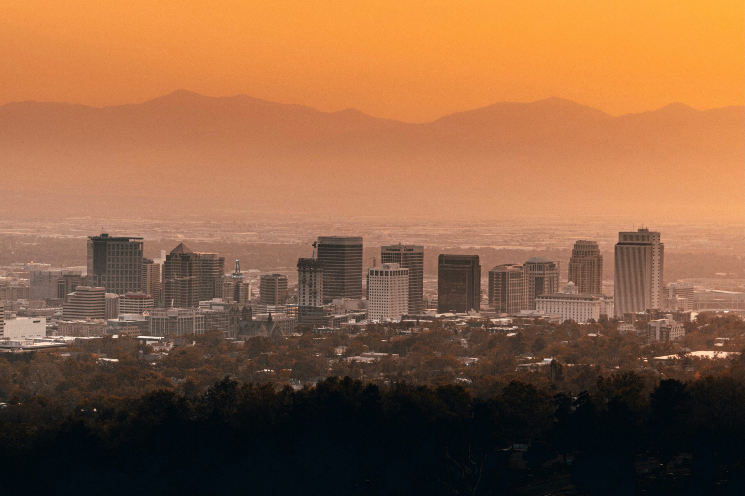 Downtown Salt Lake City skyline at sunset with the Wasatch Range in the background
