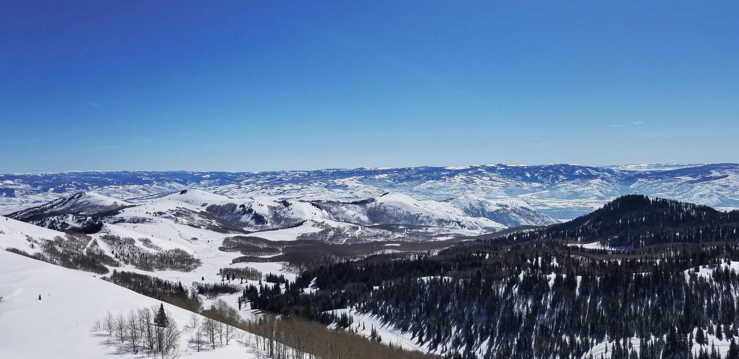 View from Park City Mountain Resort across snow-covered slopes and ski runs
