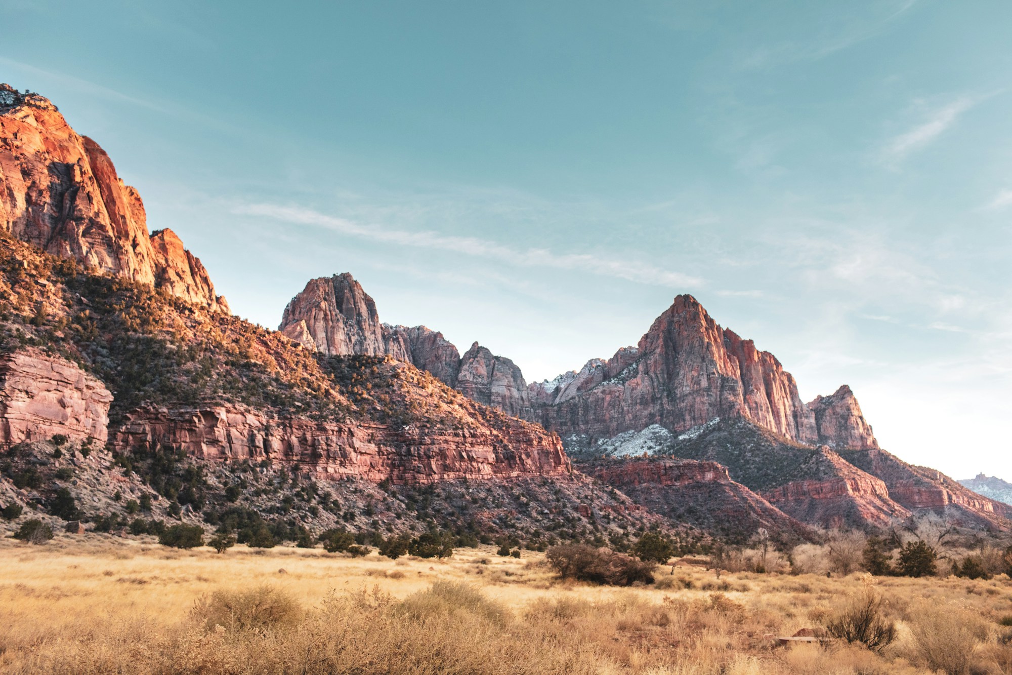 Towering red rock walls of Zion Canyon rising above the Virgin River in Zion National Park, Utah